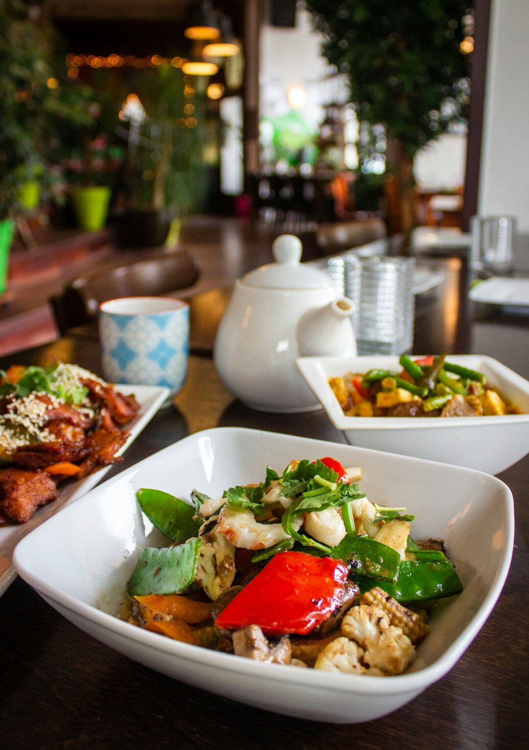 Grilled vegetables and fresh salad on a garden table in summer